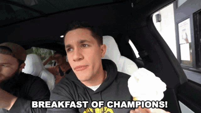 a man holding an ice cream cone with the words breakfast of champions below him
