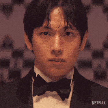 a man in a tuxedo and bow tie has a netflix logo on the bottom