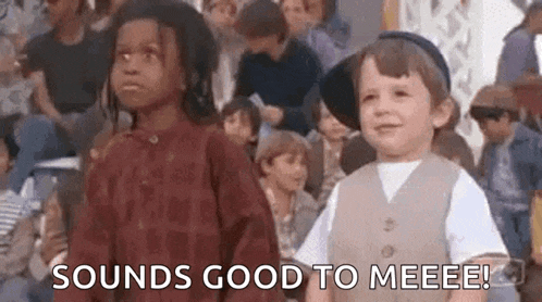 a boy and a girl are standing next to each other in a crowd of people .