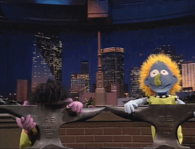 two sesame street characters standing next to an anvil that says ' ge ' on it
