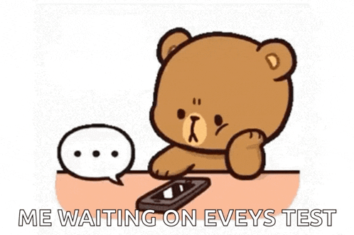 a teddy bear is sitting at a table using a cell phone and a speech bubble .