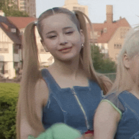 a woman with pigtails is standing next to a blonde woman