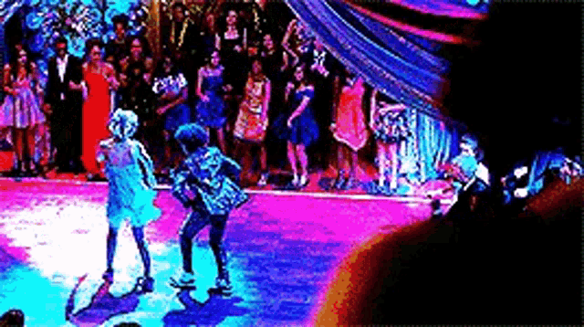 a group of people are dancing on a dance floor .