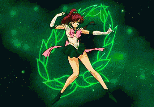 a girl in a sailor moon outfit is dancing in front of a green wreath .