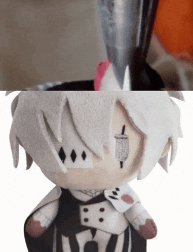 a close up of a stuffed animal with a sword in his mouth