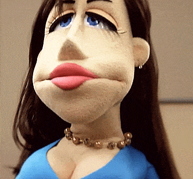 a close up of a woman 's face with a blue shirt and necklace