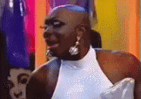 a man in a white dress is making a funny face .