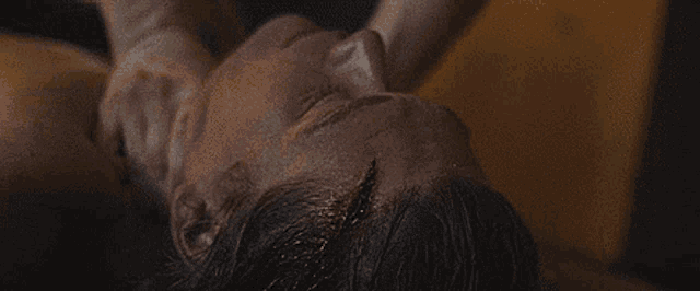 a close up of a man 's head with a stitch on it