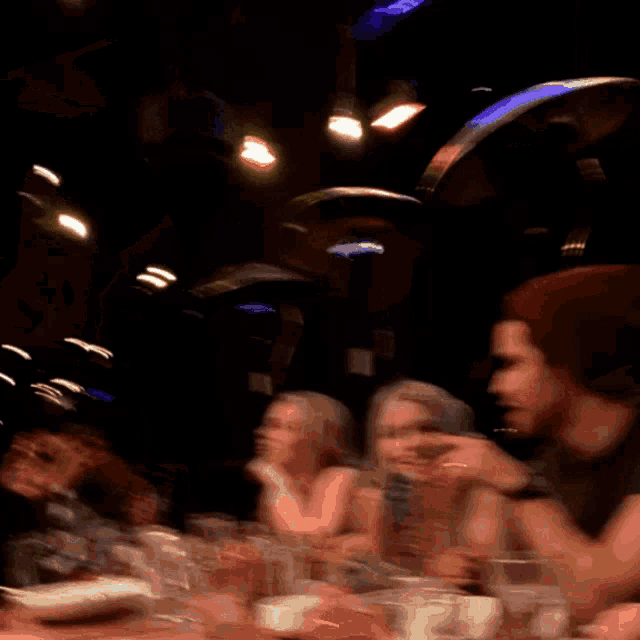 a blurry picture of people sitting at a table