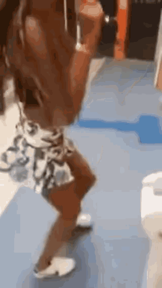 a woman in a skirt is dancing in a bathroom .