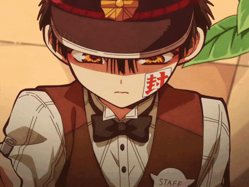 a close up of a person wearing a hat and vest with a staff badge