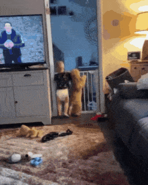a baby in a diaper is standing in front of a tv