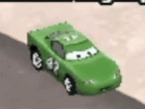 a green toy car from cars is driving down a road .