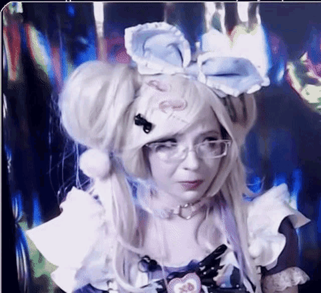 a woman wearing a wig and glasses has a heart on her head that says ' i love you ' on it