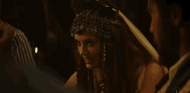 a woman wearing a headdress with the number 1 on the bottom