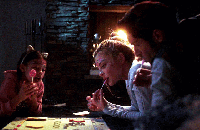 a girl with cat ears on her head is playing a board game