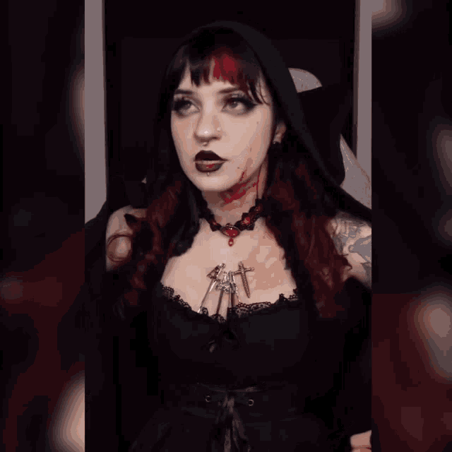 a woman with blood on her face is wearing a choker with a cross on it