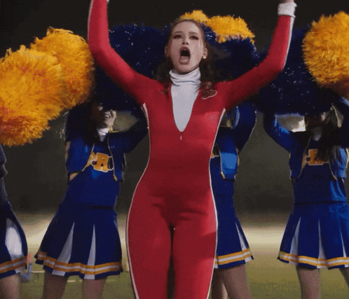 a cheerleader wearing a red bodysuit with the letter r on the front