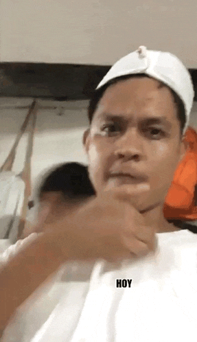 a man wearing a white hat and a white shirt has the word hoy on his shirt