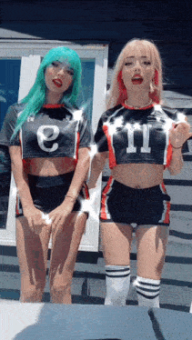 a girl with green hair is wearing a crop top that says e on it