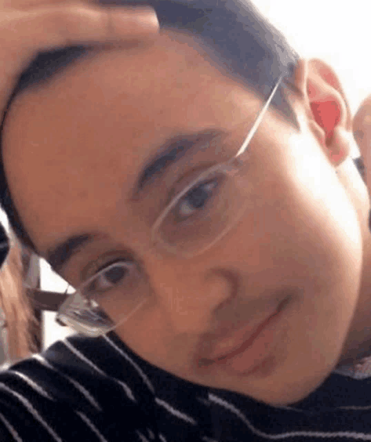 a close up of a person wearing glasses