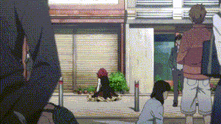 a group of people are standing on a sidewalk in front of a store .