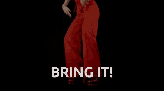 a woman in red pants is dancing with the words bring it written below her