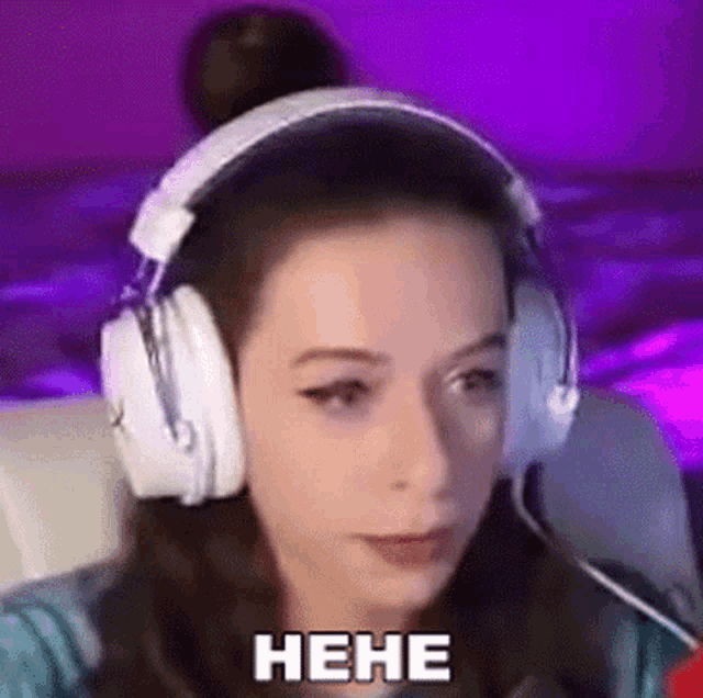 a woman wearing headphones is sitting in front of a purple background .