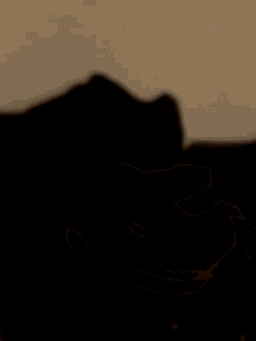 a blurred image of a person 's face with a gray background