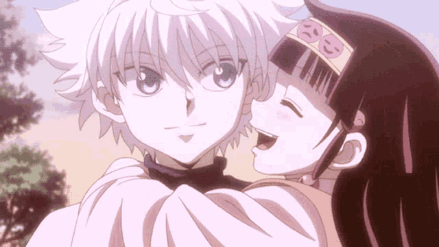 a boy and a girl are hugging each other and the girl is wearing a headband that says ' a ' on it
