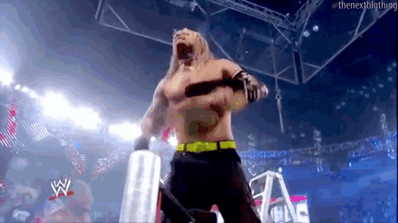 a man without a shirt is standing in a wrestling ring with the word wwe on the bottom