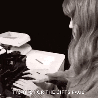 a woman is typing on a typewriter and says `` thanks for the gifts paul '' .