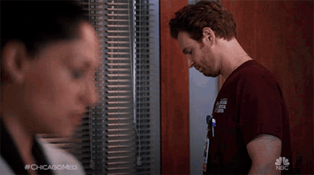 a man in a chicago medical shirt stands next to a woman in a white shirt