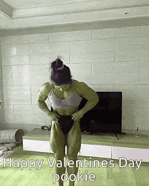 a muscular woman is standing in a living room with the words happy valentines day pookie
