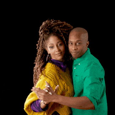a man in a green shirt and a woman in a yellow sweater are dancing