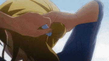 a close up of a person 's head with a person 's hands on it .