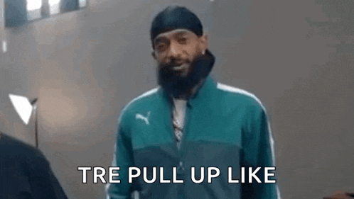 a man with a beard is wearing a green jacket and a black beanie and is saying `` tre pull up like '' .