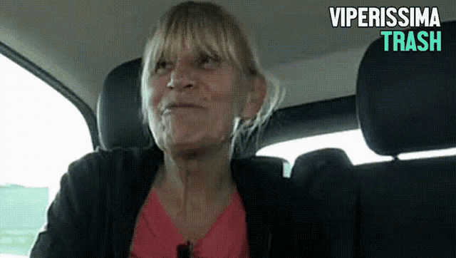 an older woman is sitting in the back seat of a car with the words viperissima trash below her