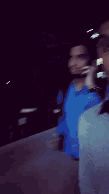 a blurry photo of a man in a blue shirt