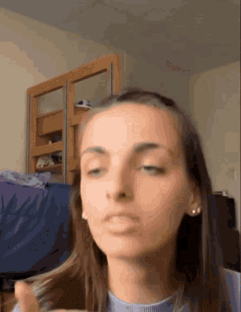 a woman is making a funny face while holding her hair