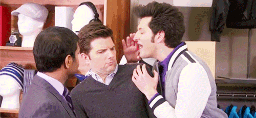 three men are standing next to each other in a store and one of them is making a funny face .