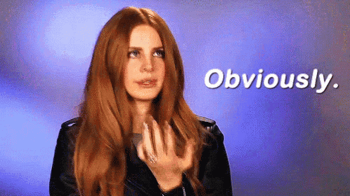 a woman with long red hair is wearing a black leather jacket and says obviously
