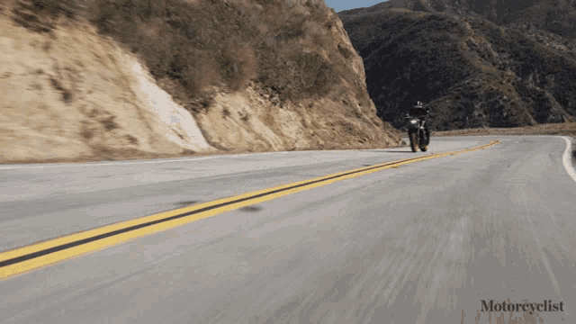 a person riding a motorcycle on a road with the words motorcyclist on the bottom