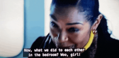a woman is smiling and talking to another woman in a room .