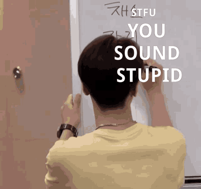 a man writes on a whiteboard that says stfu you sound stupid