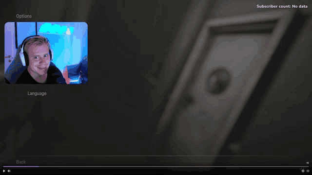 a video of a man wearing headphones is being played on a screen that says options and language