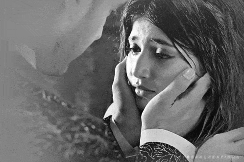 a black and white photo of a man holding a woman 's face with the word creations on the bottom left