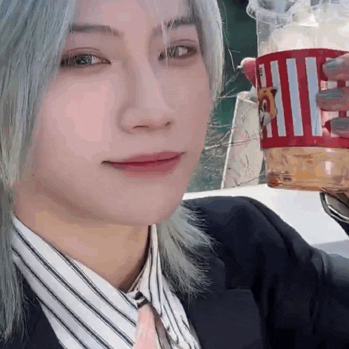 a close up of a woman holding a cup of coffee .