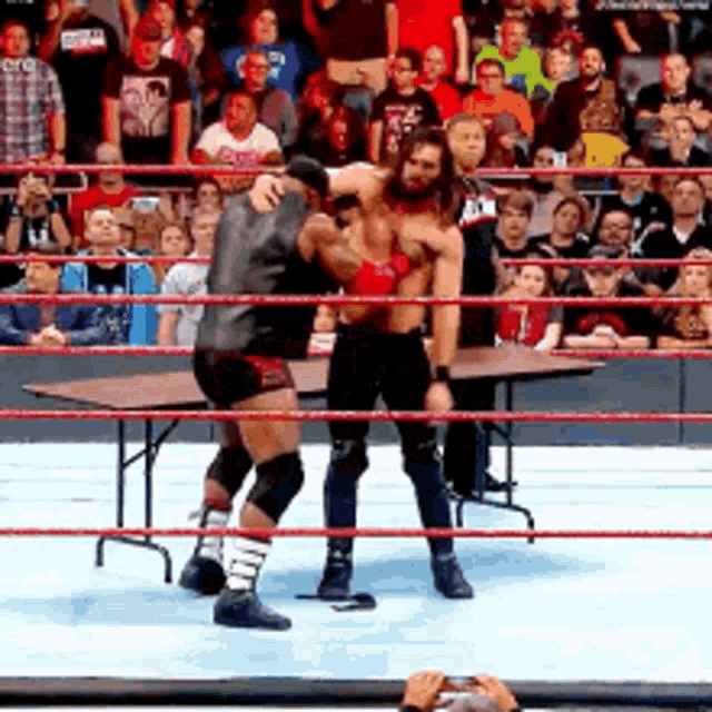 Lashley Spinebuster Through Table Rollins GIF
