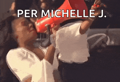 a woman is holding a megaphone in front of her face and shouting into it .
